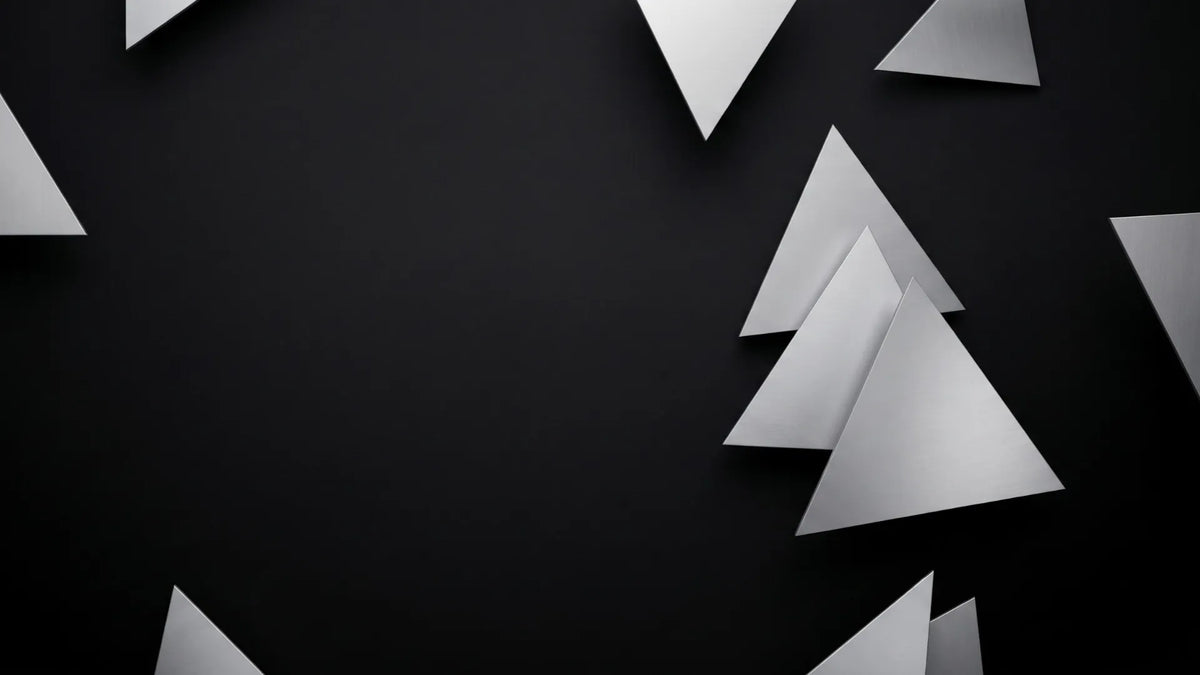 Matte silver triangles arranged at different angles against a dark background.
